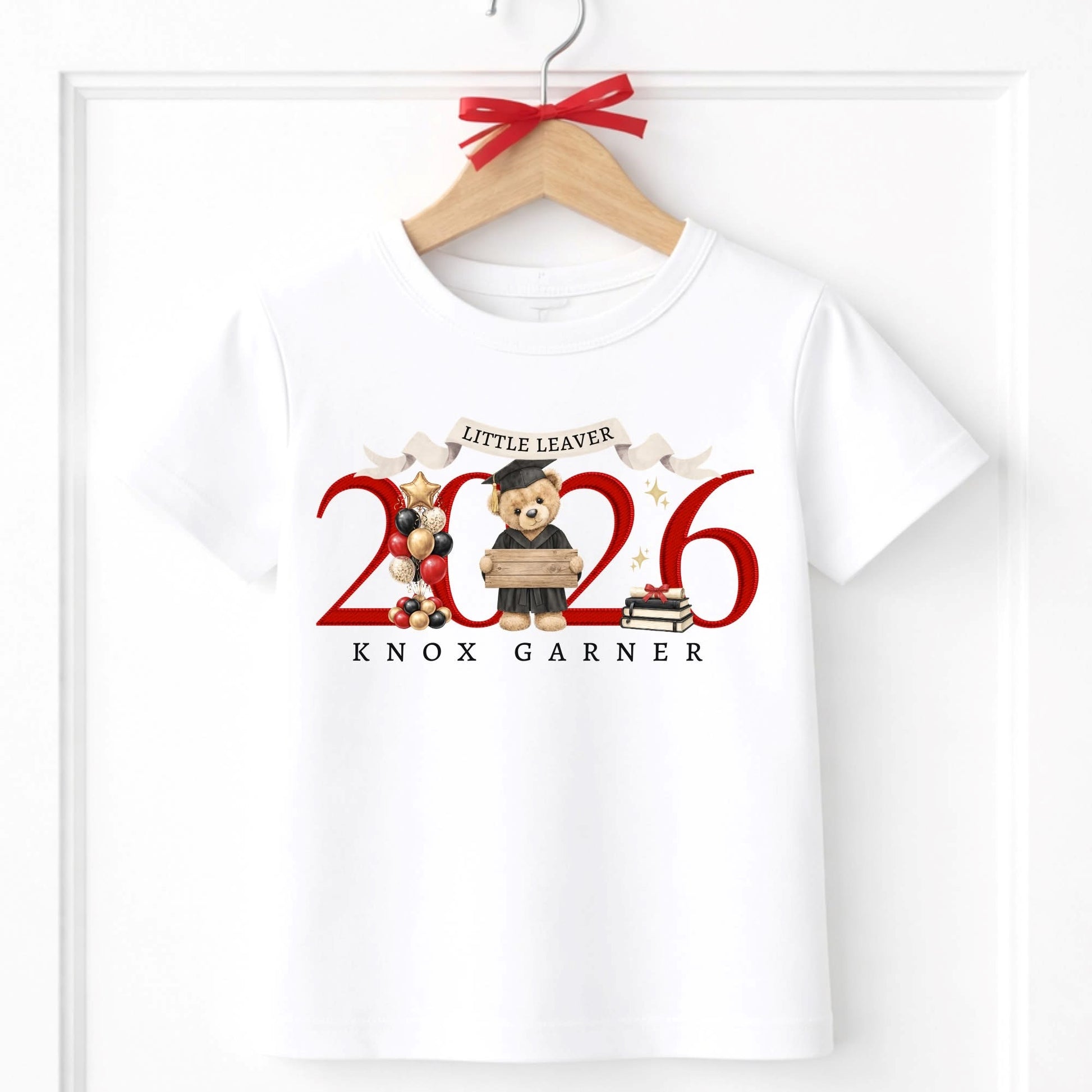 White t-shirt with 'Little Leaver 2026' design featuring bears and text, on a hanger.