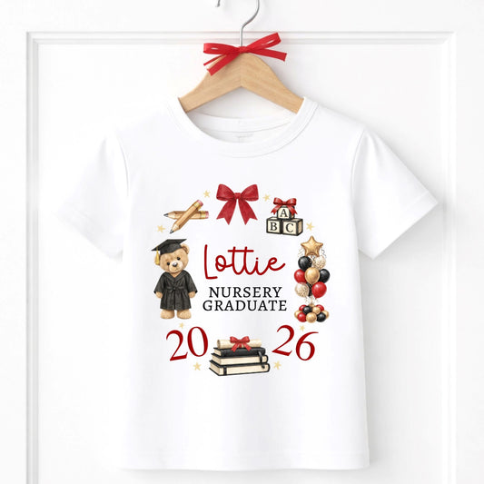 White t-shirt with graduation-themed graphics and text on a hanger.