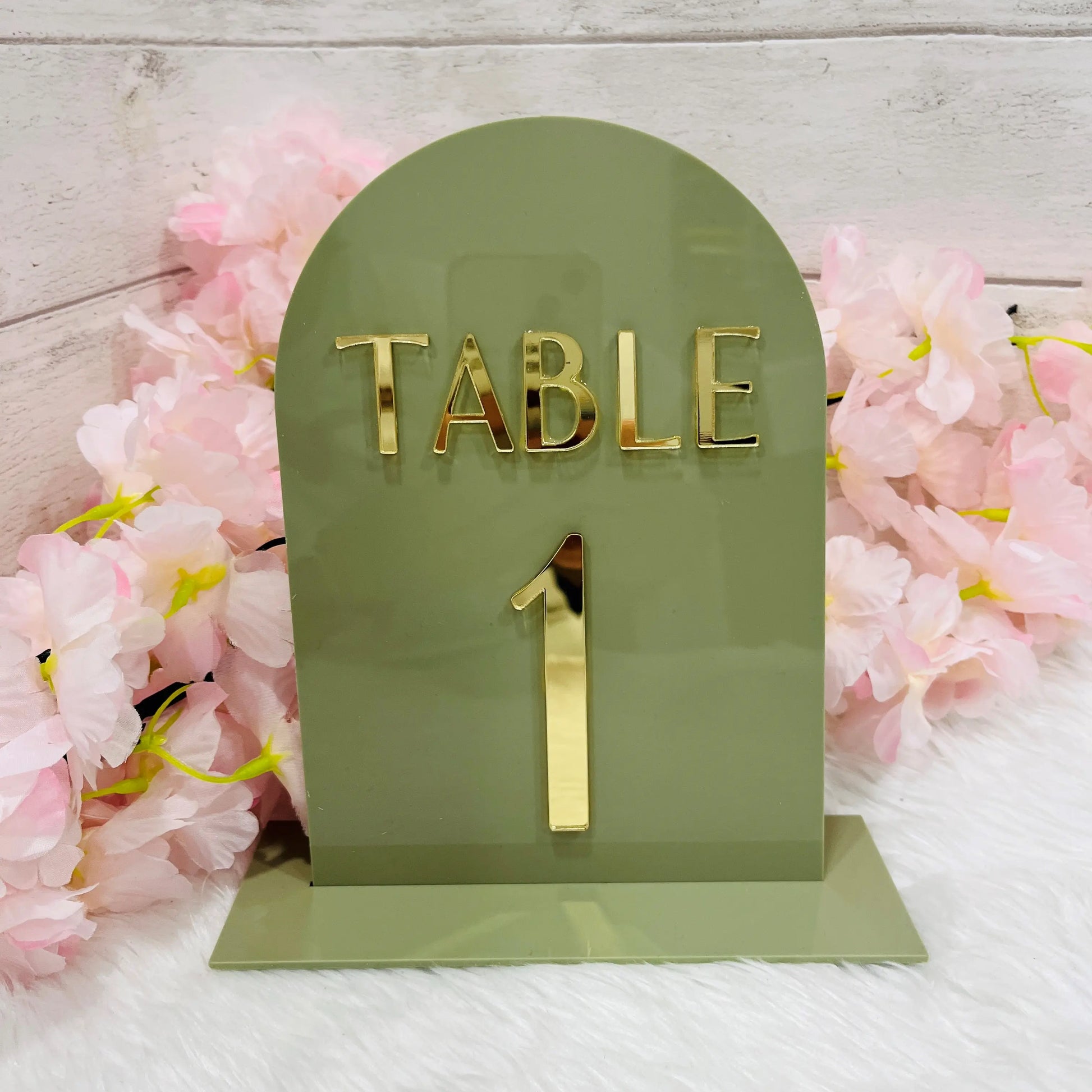 Green table number with gold 'TABLE 1' on a floral background