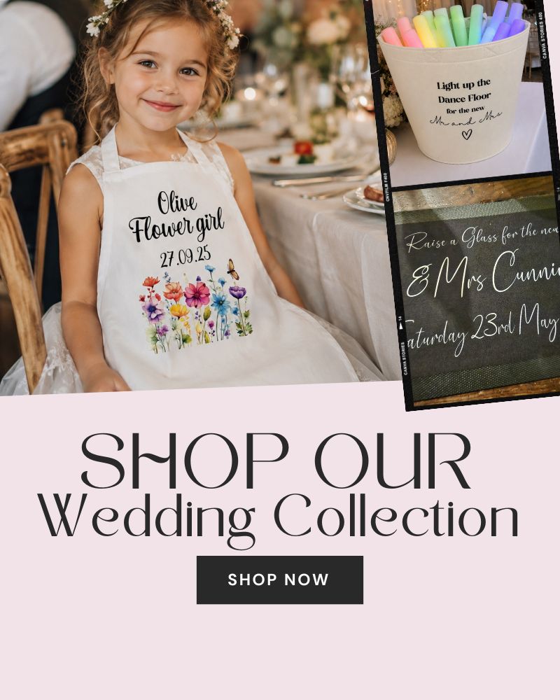 A promotional wedding collection graphic featuring a young girl wearing a white printed flower girl apron at a wedding table, alongside smaller examples of other printed white wedding-themed items and large text reading 'SHOP OUR Wedding Collection' with a 'SHOP NOW' button.